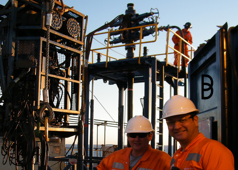 Oil and gas workers in safety gear on an offshore drilling rig, surrounded by industrial equipment. The Ballycatter logo is visible, representing the brand's role in industrial procurement and supply solutions.