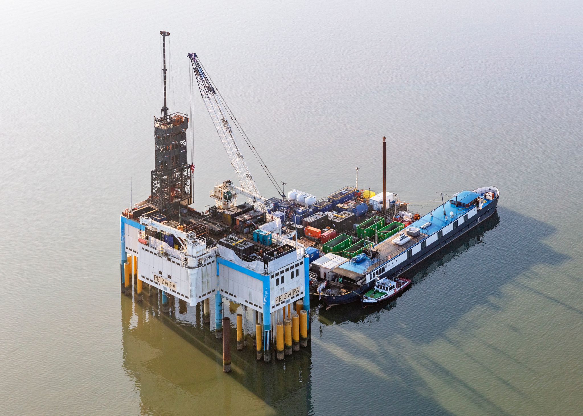 An offshore drilling platform with a supply vessel alongside, showcasing logistics and operations in the energy industry.